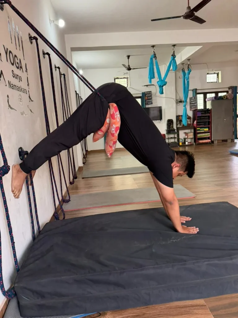 Instructor Demonstrating Rope-Assisted Yoga Pose